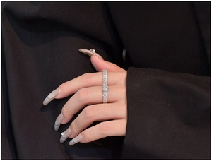 Close-up of S925 silver ring with 6mm cubic zirconia on a dark suit fabric background
