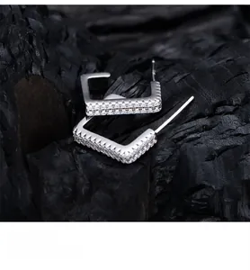 Detail of square S925 silver earrings with double-row zircon and platinum-like finish