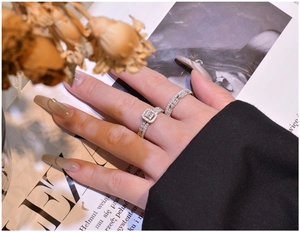 Macro detail of S925 silver halo ring set with square cubic zirconia on a vintage background