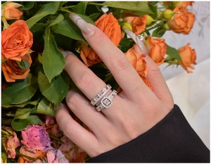 Detail of S925 silver double ring set with baguette diamonds on orange roses
