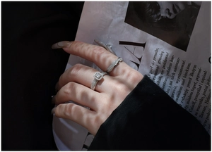 Close-up of stacked S925 silver rings with halo square cut and multi-row pave setting