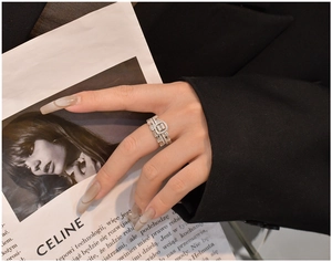Detail of S925 sterling silver stacked rings with baguette and round cut zircons