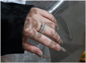 Detailed close-up of S925 sterling silver snowflake micro-pave stacked rings set on hand
