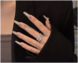 Close-up of 925 silver wedding set with a round solitaire and baguette eternity band