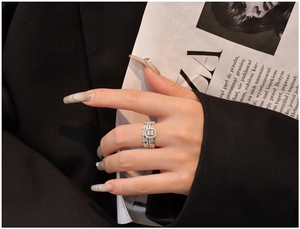 Close-up of S925 silver stacked rings with baguette and round-cut cubic zirconia stones