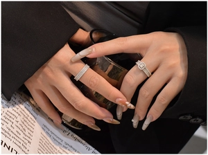 Macro detail of silver S925 rings with micro-pave crystals shown on hand wearing black suit