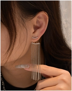 Detailed close-up of 925 silver long tassel earrings with sparkling diamond-set double arches