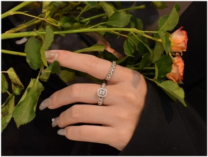 Close-up of S925 silver twist rings set with sparkling zircon stones on female hand