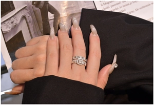 Detail of S925 silver layered ring set with large rectangular zircon on a female hand