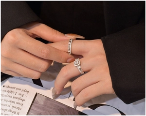 Detail of stacked S925 silver rings with baguette and round cut zirconia on finger