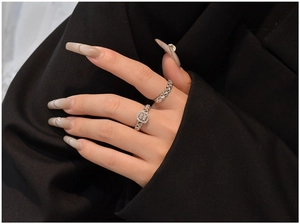 Detail of S925 sterling silver twist rings with sparkling zirconia on a hand