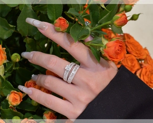 Close-up of sparkling S925 sterling silver stacked rings with rectangular and round gems