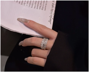 Close-up of S925 sterling silver ring set with micro-pave zirconia on a black blazer