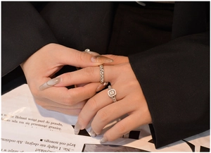 Close-up of S925 silver chain rings with sparkling micro-pave crystals on a model hand