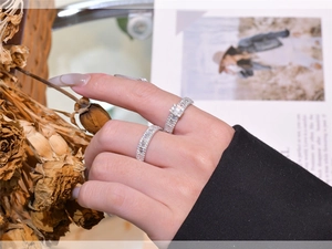 Detail of silver S925 rings with rectangular zircon stones worn in a lifestyle setting
