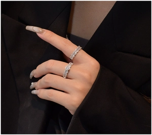 Macro view of two S925 silver rings with baguette and round cut micro-pave crystals