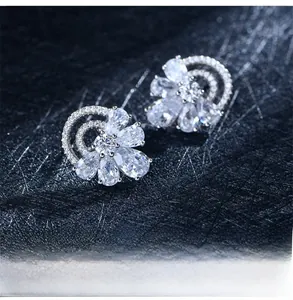 Macro shot of silver S925 flower stud earrings with sparkling cubic zirconia crystals