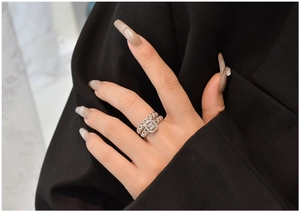 Close-up of S925 silver emerald cut ring set with shimmering pave diamond accents