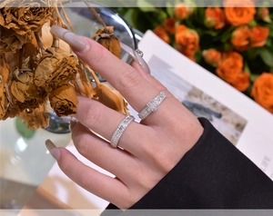Close-up of S925 sterling silver stacked rings with emerald cut and round cubic zirconia
