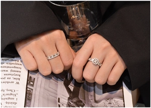 Macro shot of silver sterling nesting ring set with emerald cut stones on a Vogue magazine