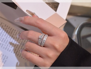 Detail of S925 sterling silver stacked rings with baguette and round zircon stones