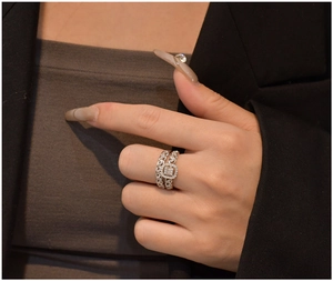 Detail of silver S925 halo square cut ring and chain style eternity band set on hand