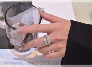 Macro shot of 925 silver double ring set with rectangular stone on model's hand