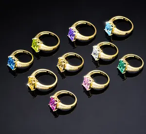 Collection of rectangle cut colorful diamond rings on a reflective black background