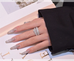 Close-up of elegant S925 sterling silver stacked rings with rectangular cut crystals