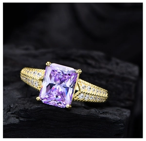 Macro shot of 14k gold-plated ring featuring a large purple gemstone with pavé setting