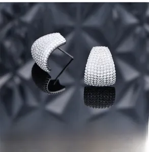 Macro shot of 925 silver stud earrings with micro-pave diamonds and platinum plating