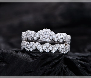 Macro detail of S925 silver bridal set rings with micro-pave crystals on charcoal
