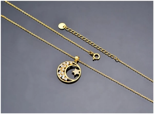 Macro shot of S925 sterling silver star and moon necklace with white zircon in gold finish