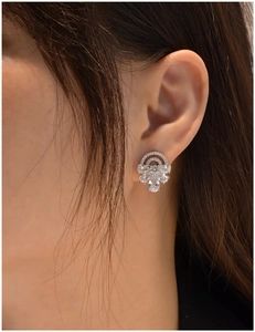 Macro shot of S925 sterling silver half-arch stud earrings with sparkling pavé zircons