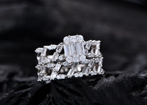 Detailed close-up of S925 silver emerald cut diamond ring set on dark rock texture