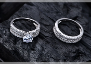Macro shot of 925 sterling silver luxury wedding ring set on charcoal background