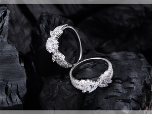 Macro detail of S925 sterling silver stamp and zircon pavé setting on matching rings