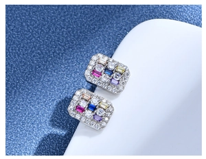 Macro detail of sterling silver rectangle stud earrings with vibrant multi-color zircons