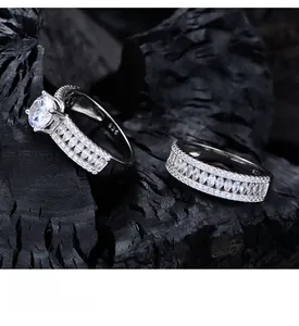 Detail of 925 sterling silver ring set with six-claw round cut cubic zirconia on black wood