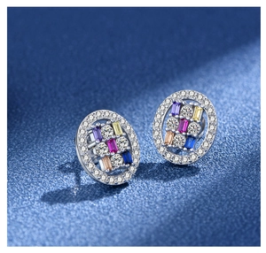 Macro detail of oval sterling silver earrings featuring multi-color gemstones and zircons