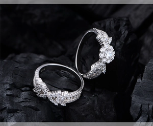Macro shot of S925 silver snowflake ring set with white zircons on dark stone base