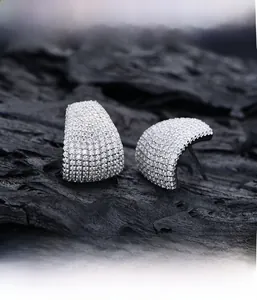 Detailed macro view showing precision micro-pave setting on silver arched earrings