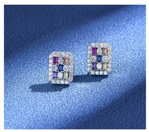 Macro detail of rectangle earrings with micro-pave diamonds and multi-colored stones