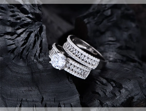 Macro shot of silver wedding ring set with marquise cut diamonds on charcoal background