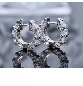 Close-up of S925 silver C-shaped earrings with micro-paved diamonds and marquise accents