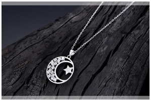 Macro shot of S925 sterling silver star and moon necklace with cubic zirconia