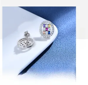 Macro shot of S925 silver oval studs featuring multi-colored step-cut cubic zirconia