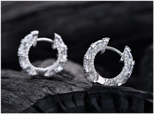 Macro shot of S925 sterling silver huggie earrings with brilliant cubic zirconia pavé