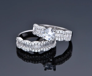 Detail of wavy S925 silver wedding set with large round zircon and baguette cut stones
