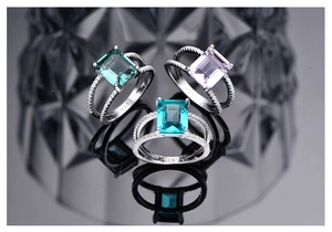 Detailed view of three 925 silver rings with emerald, purple, and blue rectangular gems